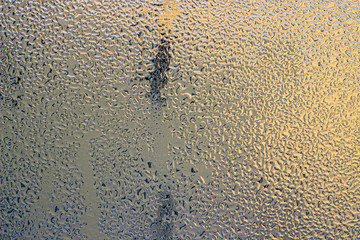 The fog on the glass. Morning outside the window. Rainy weather Background.