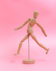 Wood doll on pink background