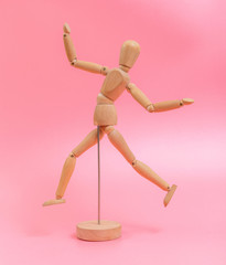 Wood doll on pink background
