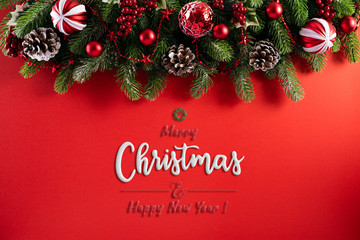 Christmas background concept. Top view of Christmas gift box red balls with spruce branches, pine cones, red berries star and bell on red background.