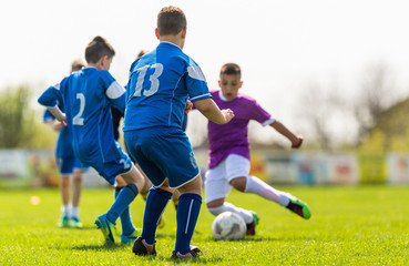 Kids soccer football - children players match on soccer field