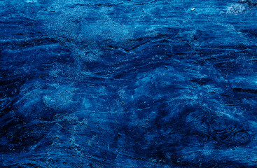 Top view of dark stone background in blue color.