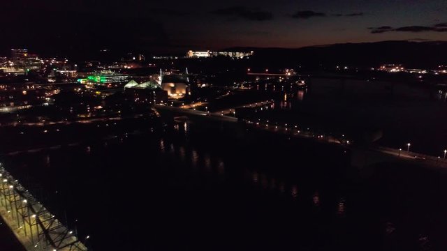 High aerial night flight from the Market Street bridge, to reveal the Walnut Street Pedestrian Bridge lights in Chattanooga Tennessee