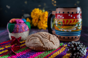Fototapeta premium Concha Bread, Mexican Sweet Scone and Coffee Jar on Woven Tablecloth.