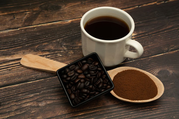 Roasted coffee beans, ground coffee, Cup of coffee, Wooden spoon with roasted coffee