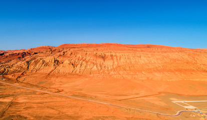 The Flaming Mountains are barren eroded red sandstone hills in Tian Shan Mountain range Xinjiang China.