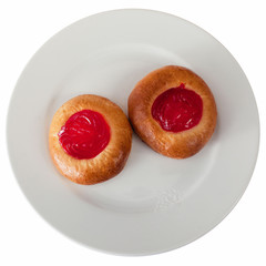 Two round buns with red cream on a plate