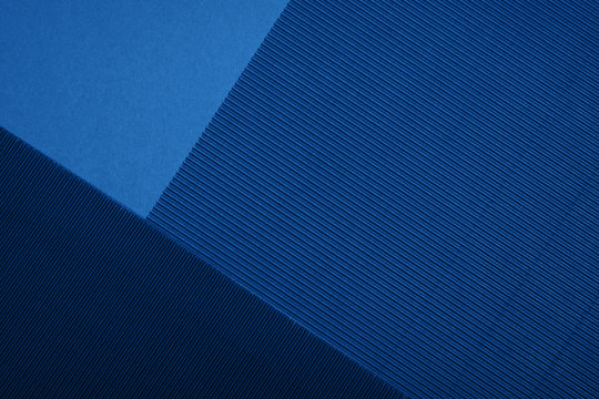 Abstract textured geometric paper in blue color background.