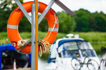 Rescue red lifebuoy life ring in port