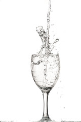 fast flow of wine in a glass, splash and spray black and white