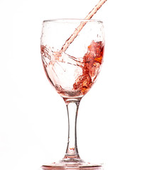 pouring red wine into a glass, strong flow and splash