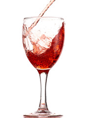 pouring red wine into a glass, strong flow and splash