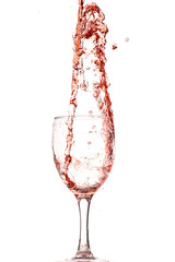 pouring red wine into a glass, strong flow and splash