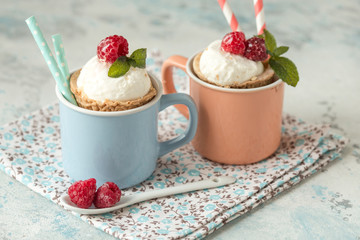 Homemade  vanilla ice cream with fresh mint in color cup. Sweet berry summer dessert. concrete background copy space