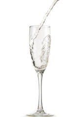 pouring white wine, champagne into a tall glass, strong flow and splash
