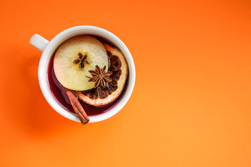 Christmas mulled wine on a wooden table. Traditional hot drink at Christmas (red wine with spices,...