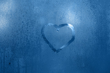 Color of the year 2020 - Classic Blue. Rain, heart on a wet window