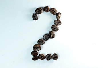Coffee Been, the number two is formed with coffee beans in white background