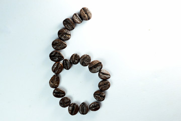 Coffee Been, the number six is formed with coffee beans in white background