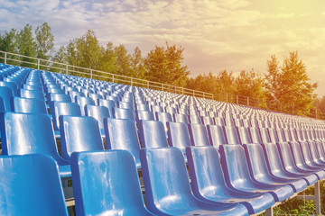 Fototapeta premium empty seats in an outdoor stadium. The concept of the lack of spectators.