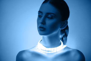 High Fashion woman in colorful bright neon uv blue and purple lights, posing in studio, beautiful...