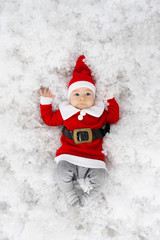 Funny little boy in Santa costume is ready to celebrate Christmas and New Year. Christmas card