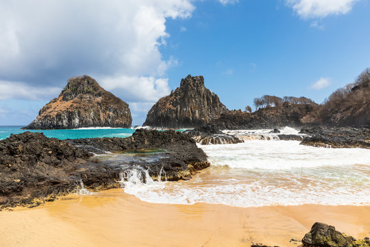 View of Two Brothers Mountain (Morro dos Dois Irm&atilde;os in Portuguese) from Baia dos Porcos in Fernando de Noronha, Brazil. A natural pool can be seen in the picture.