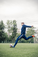 Fototapeta na wymiar Football player kicks the ball 