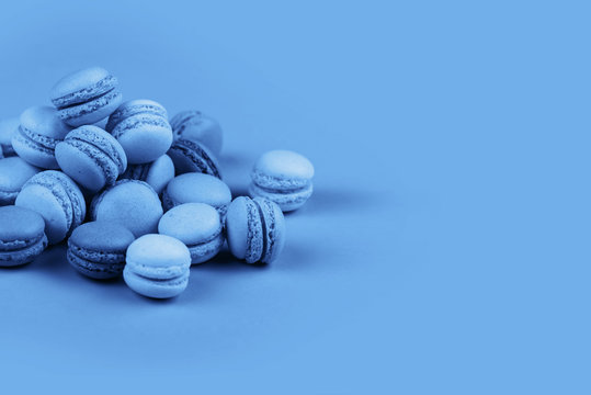 Group of Ultra Violet and blue macaronscorn on trendy blue background.