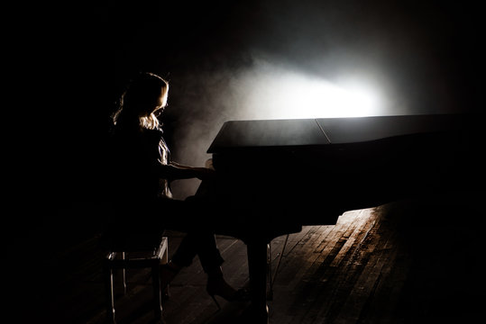 Pianist musician piano music playing. Musical instrument grand piano with woman performer