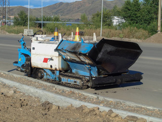 Special equipment for road construction. Asphalt paver on the road. Asphalt paver machine