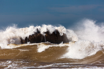 Big waves on a sea with blue background in Essaouira, Morocco.