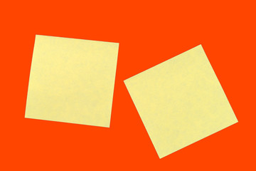 Yellow sticker notes on a bright orange red. Business background, copy space