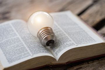 The holy bible with light bulb.