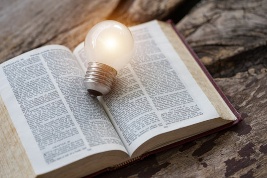 The holy bible with light bulb.