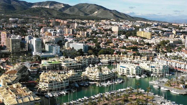 4K Drone footage of the port Puerto Marina in Benalmadena with boats, city and mountains