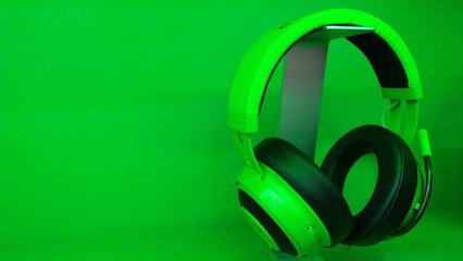 headphones on green background close up