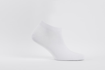 Blank white cotton short sock on invisible  foot on white background as mock up for advertising, branding, design, side view, template.