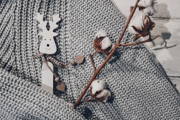 Cotton branch, deer figurine, sweater