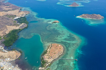 Naklejka premium Beautiful view the Manjaja Island with blue and grean ocean, traditional wooden jetty and fisherman village located in Labuan Bajo, Indonesia. The popular destination for tourism.