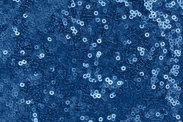 Shiny fabric with sequins, abstract background toned blue color.