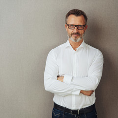 Man in glasses and white shirt, arms folded