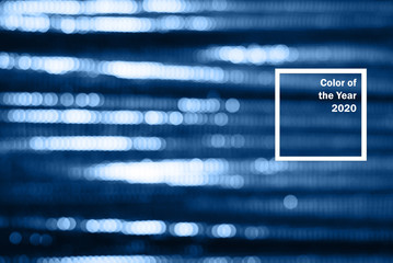 Blue shiny fabric with sequins, blured abstract background.