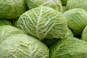 Cabbage on the market background. Fresh cabbage from farm field. Close up macro view of green...