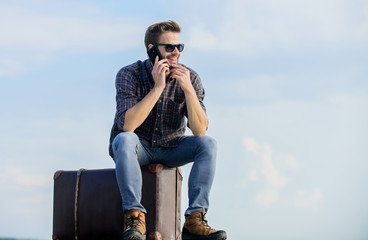 Travel blogger. Man sit on suitcase before journey. Transportation facilities. Handsome traveler....