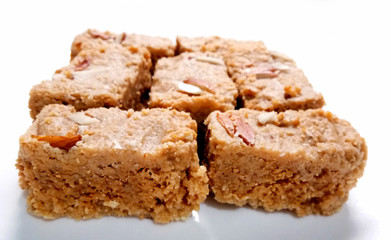 Indian Diwali Sweet Food Kalakand Also Know as Halwa or Mawa Kalakand is a Creamy Delicacy Made From Paneer or Cottage Cheese, The Dish Originated in Alwar, Rajasthan. Isolated on White Background