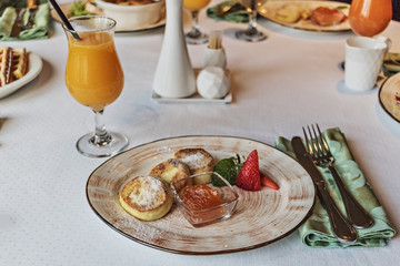 Cheesecakes with jam and strawberries in a plate. Breakfast.
