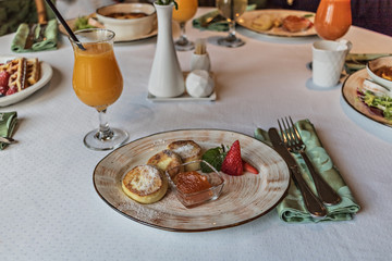 Cheesecakes with jam and strawberries in a plate. Breakfast.