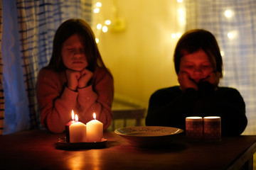 Magic two children guess with candles in the dark