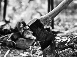 an ax sticking out against a bonfire